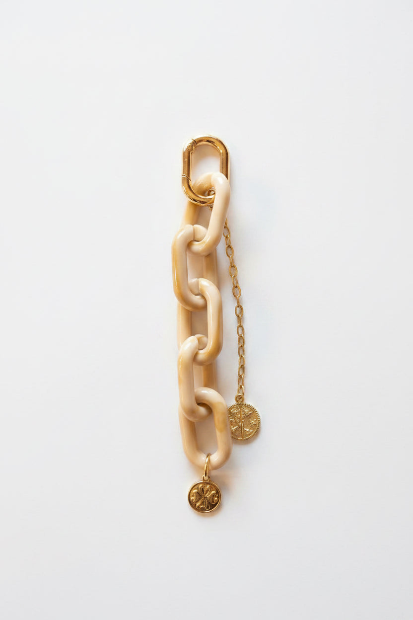 Beige resin and gold bag charm
